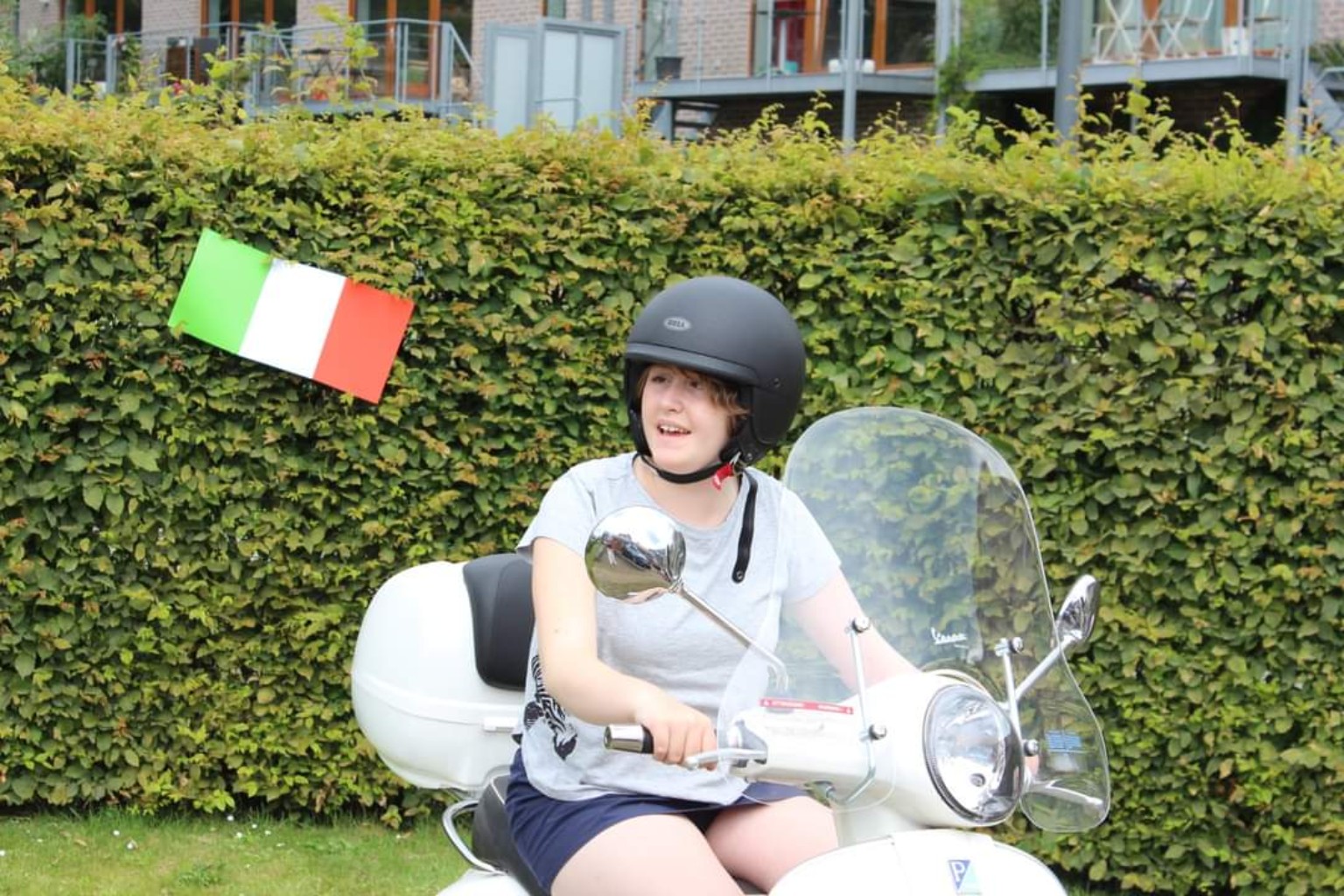 Lou sur un scooter décoré du drapeau italien